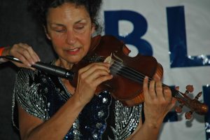 Kitty McIntyre, bluegrass fiddler for Vernon McIntyre's Appalachian Grass, doing her trick fiddle act