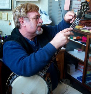 picture of Vernon McIntyre repairing a banjo at his store Famous Old Time Music Company