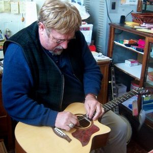 Vernon McIntyre, bluegrass musician, doing a guitar repair