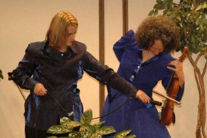 Kitty McIntyre doing Trick Fiddle act at bluegrass festival