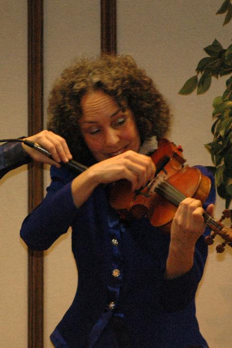 Kitty McIntyre, bluegrass fiddler for Vernon McIntyre's Appalachian Grass, doing her trick fiddle act