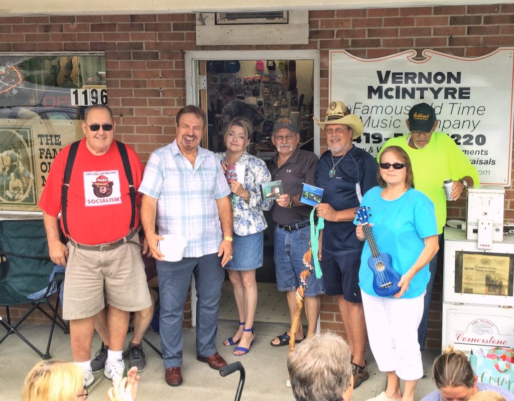 picture of Vernon with winners of various door prizes in front of store at Vernon McIntyre's Famous Old Time Music Company Grand Opening August 31, 2019